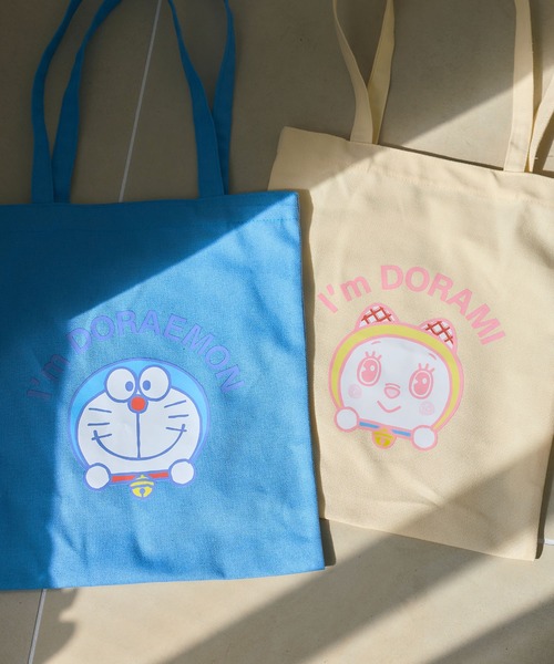 cross marche(クロスマルシェ)の「【Im Doraemon/アイム ドラえもん】フェイスプリントトートバッグ/エコバッグ《ドラえもん/ドラミちゃん》(トートバッグ・レディース・イエロー/ブルー・FREE)」の1枚目の写真