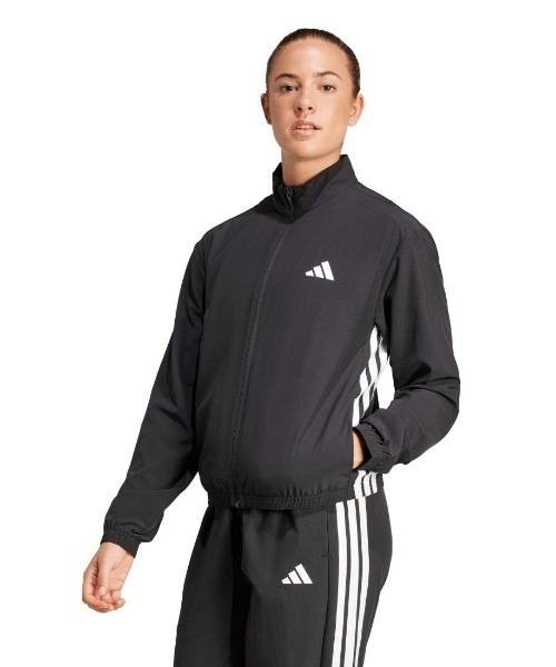 adidas(アディダス)の「アディダス adidas トレイン エッセンシャルズ スリーストライプス ウーブン ウォームアップジャケット(ジャージ・レディース・ベージュ/ブラック・S/M/L)」の2枚目の写真