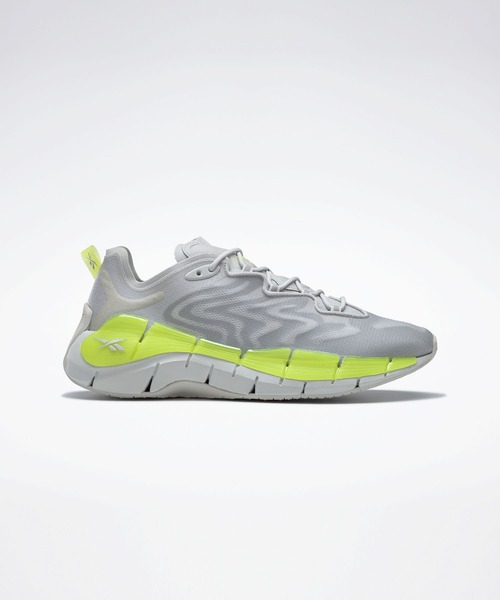 Reebok(リーボック)の「ジグ キネティカ II / Zig Kinetica II Shoes(スニーカー・メンズ・ベージュ系その他/グレー系その他/ブラック×レッド・26.5cm/28.0cm/23.5cm/25.0cm/28.5cm/25.5cm/27.0cm/24.5cm/26.0cm/22.5cm/24.0cm/27.5cm/29.0cm/23.0cm)」の1枚目の写真