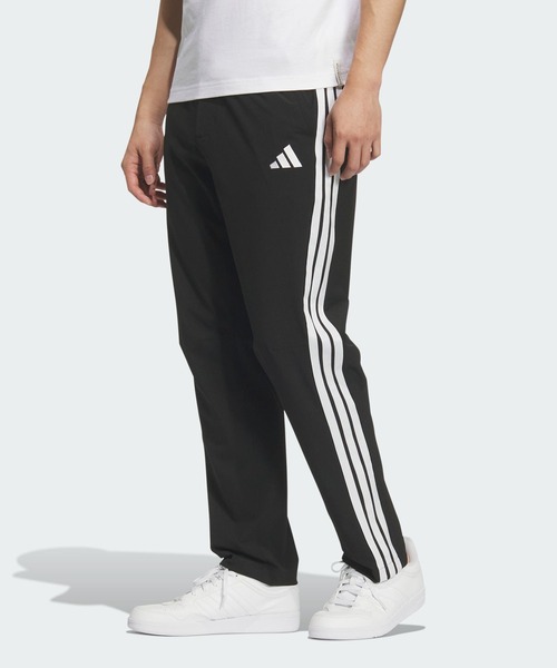 adidas(アディダス)の「ストレッチ ツイル レギュラーフィット テーパードレッグ 10分丈 オープンヘム パンツ / アディダス adidas(スウェットパンツ・メンズ・ブラック×ホワイト・XX-LARGE/3XL/LARGE/MEDIUM/SMALL/X-LARGE/X-SMALL)」の1枚目の写真
