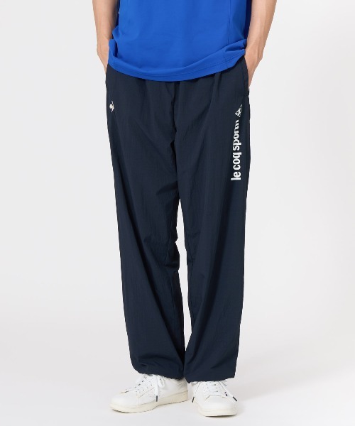 le coq sportif(ルコックスポルティフ)の「【はっ水】ナイロンウィンドブレーカーパンツ(その他パンツ・メンズ・ネイビー/ブルー・M/L)」の1枚目の写真