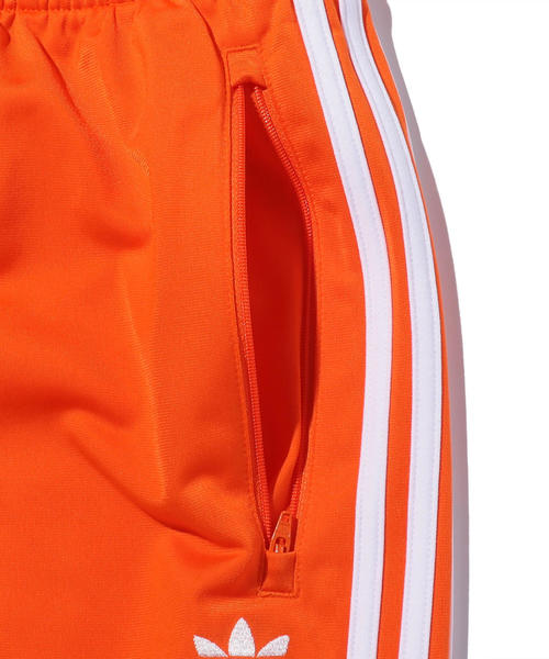 adidas adicolor オレンジ トレーニングパンツ adidas Originals（アディダスオリジナルス）の「＜adidas
