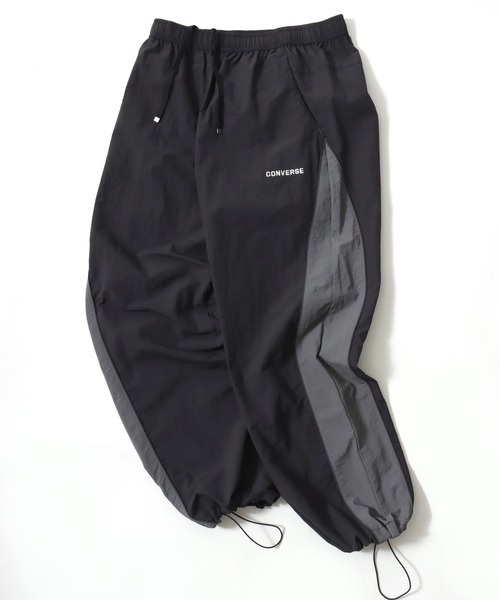 CONVERSE（コンバース）の「CONVERSE/コンバース 撥水 オーバーサイズ パイピング ナイロンパンツ/トラックパンツ/レディース メンズ（その他パンツ・レディース・ブラック/ネイビー/アイボリー・LL/L/M）」の2枚目の写真