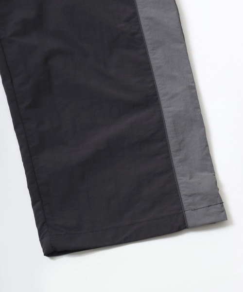 CONVERSE（コンバース）の「CONVERSE/コンバース 撥水 オーバーサイズ パイピング ナイロンパンツ/トラックパンツ/レディース メンズ（その他パンツ・レディース・ブラック/ネイビー/アイボリー・LL/L/M）」の19枚目の写真