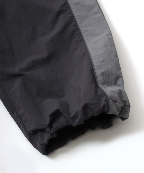 CONVERSE（コンバース）の「CONVERSE/コンバース 撥水 オーバーサイズ パイピング ナイロンパンツ/トラックパンツ/レディース メンズ（その他パンツ・レディース・ブラック/ネイビー/アイボリー・LL/L/M）」の20枚目の写真