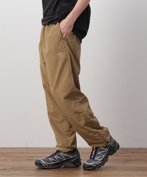 MANASTASH(マナスタッシュ)の「MANASTASH×MASTERPIECE SOUND/マナスタッシュ×マスターピースサウンド/TRACK PANTS/トラックパンツ(その他パンツ・メンズ・ブラック/タン・L/XL/S/M)」の1枚目の写真