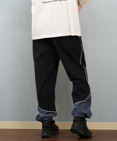 NEW ERA(ニューエラ)の「NEW ERA/ニューエラオーバーサイズド パイピング トラックパンツ ロンパン セットアップ対応 14674815/14674816(その他パンツ・メンズ・ブラック/ネイビー・2XL/M/XL/L)」の12枚目の写真