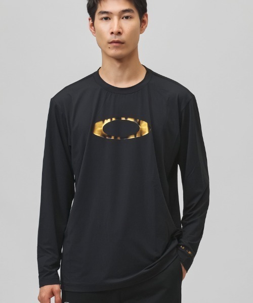 OAKLEY(オークリー)の「オークリー OAKLEY ENHANCE QD LS TEE BOLD EVO 5.7(Tシャツ/カットソー・メンズ・ブラック×ゴールド・M/LL/L/S)」の1枚目の写真