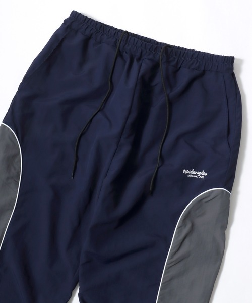 Mark Gonzales（マーク・ゴンザレス）の「MARK GONZALES ARTWORK COLLECTION/マークゴンザレス 別注 オーバーサイズ パイピング ナイロンパンツ/トラックパンツ/レディース メンズ（その他パンツ・メンズ・グレー/ネイビー/ブラック・XL/L/M）」の12枚目の写真