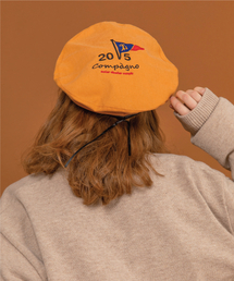 CPGN STUDIO（コンパーニョ）の「5th anniversary flag logo ベレー帽マスタード（ハンチング/ベレー帽）」