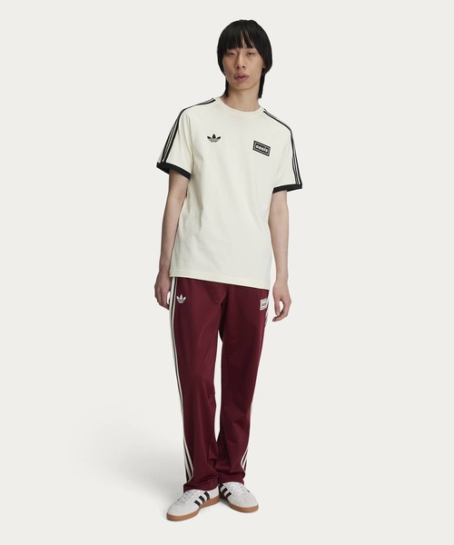 adidas Originals × Oasis ツアースリーストライプス Tシャツ