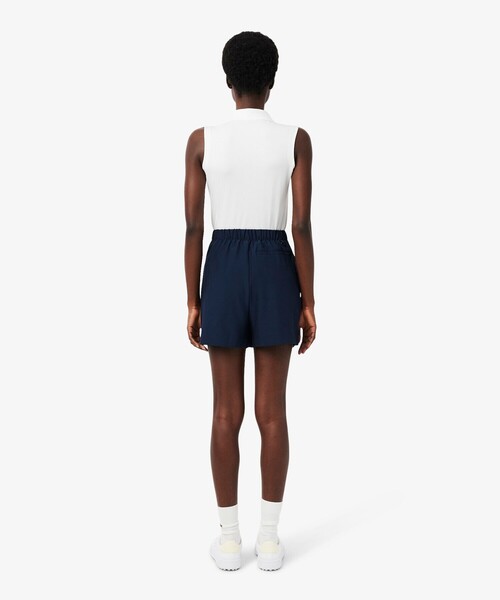 LACOSTE(ラコステ)の「吸汗速乾 ウルトラドライ フラップデザインストレッチテニスショーツ / ミニスカート(スカート・レディース・ネイビー/ホワイト・36/38/34)」の4枚目の写真