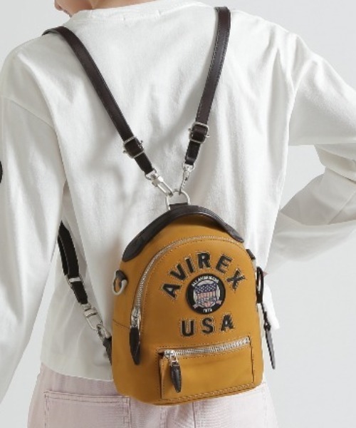AVIREX(アヴィレックス)の「《直営店限定》LX VARSITY LEATHER MINI BACK PACK(バックパック/リュック・レディース・マスタード・F)」の1枚目の写真