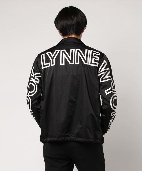 VENCEEXCHANGE(ヴァンスエクスチェンジ)の「ポリメモリービッグロゴコーチジャケット(ブルゾン・メンズ・オリーブ/ブラック・MEDIUM/LARGE)」の4枚目の写真