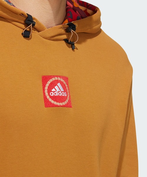 adidas（アディダス）の「CNY グラフィック フード付きスウェット 