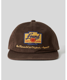 HUMAN N CAT（ヒューマンアンドキャット）の「パウンドイエロー ワッペン フラットブリムキャップ [ブラウン]（キャップ）」