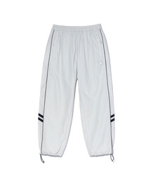 ACEI（アセイ）の「Wappen decorated piping color blocking track pants (UNI) light gray（スウェットパンツ）」