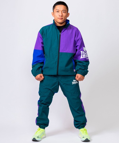 LONSDALE（ロンズデール）の「LONSDALE/ロンズデール セットアップ対応可 ワンポイントロゴ リフレクタープリント 両脇ポケット オーバーサイズ 配色 裏起毛 保温 ウォームアップ トレーニング ナイロンワッシャーパンツ（その他パンツ・メンズ・パープル/グリーン/ブラック・M/L/LL）」の6枚目の写真
