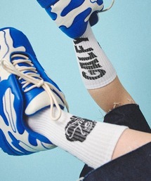 A‘gem 9（エージェムナイン）の「A'GEM/9 × .kom 『GALFY/ガルフィー』ロゴJQDソックス（ソックス/靴下）」