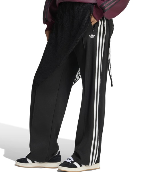 adidas(アディダス)の「adidas 2IN1 FIREBIRD LOOSE TRACK TROUSERS WITH LACE SKIRT / アディダス レーススカート付き 2イン1 ファイヤーバード ルーズ トラックパンツ(その他パンツ・レディース・ブラック・S/M/L)」の1枚目の写真