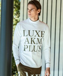 LUXEAKMPLUS（リュクスエイケイエムプラス）の「LUXEAKMPLUS(リュクスエイケイエムプラス)ゴルフ ビックロゴモックネックロングTシャツ（Tシャツ/カットソー）」