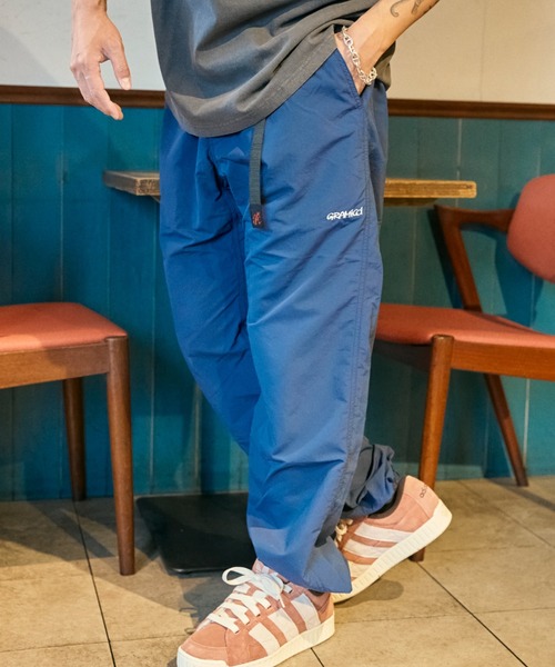 ムラサキスポーツ(ムラサキスポーツ)の「【ムラサキスポーツ限定】GRAMICCI×DEAR LAUREL ナイロントラックパンツ 水陸両用 撥水 セットアップ対応 GMP5-S2007(その他パンツ・メンズ・ブラック/ネイビー・M/L/XL)」の1枚目の写真