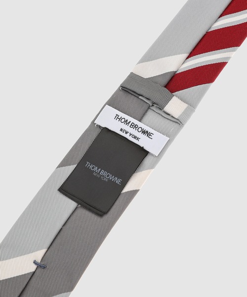THOM BROWNE(トムブラウン)の「THREE PANEL FUNMIX CLASSIC TIE IN WIDE REP STRIPE SILK COTTON MOGADOR MED GREY(ネクタイ・メンズ・グレー系その他/その他・ONE SIZE)」の5枚目の写真