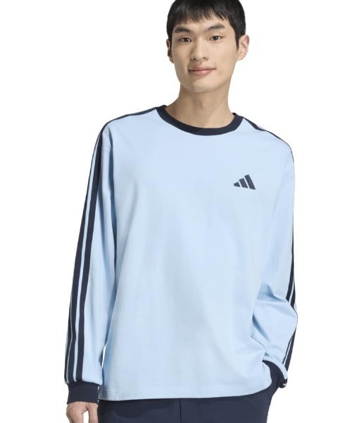 adidas(アディダス)の「アディダス adidas エッセンシャル プラス ルーズフィット スリーストライプス シングルジャージー 長袖Tシャツ(Tシャツ/カットソー・メンズ・サックスブルー/アイボリー・LL/S/M/L/3L)」の1枚目の写真