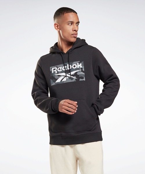 Reebok(リーボック)の「カモ オールオーバー プリント プルオーバー フーディー / Camo Allover Print Pullover Hoodie(パーカー・メンズ・ブラック・SMALL/MEDIUM/LARGE/X-LARGE/XX-LARGE/X-SMALL/XXX-LARGE)」の1枚目の写真