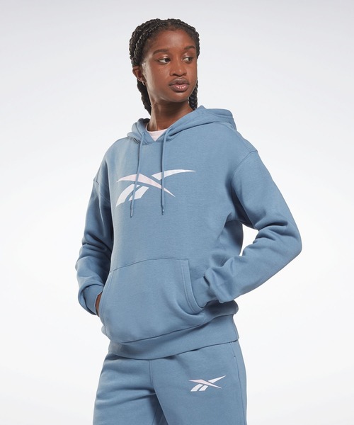 Reebok(リーボック)の「トレーニング エッセンシャルズ ベクター フーディー / Training Essentials Vector Hoodie(パーカー・レディース・ライトピンク/ライトブルー・X-SMALL/X-LARGE/MEDIUM)」の1枚目の写真