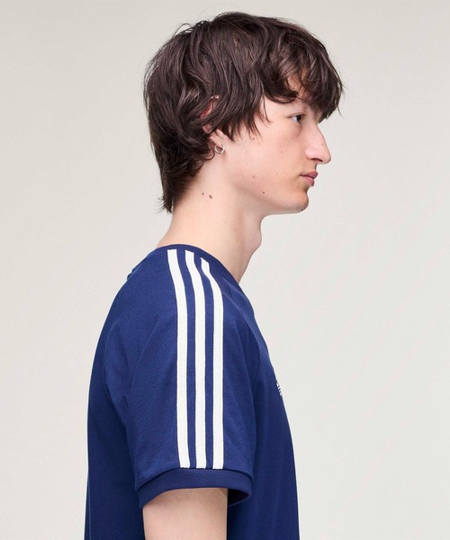adidas Originals × Oasis ツアースリーストライプス Tシャツ