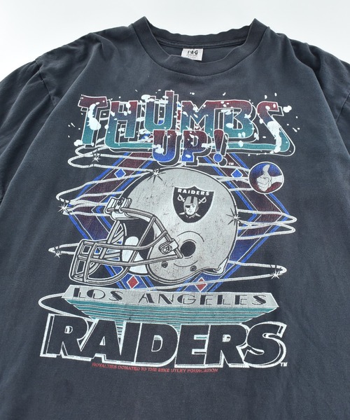 NBA/NFL/NHL/MLB(エヌビーエーエヌエフエルエヌエイチエルエムエルビー)の「【USED】90's T.A.G "RAIDERS THUMBS UP!" マルチプリント Tシャツ USA製(Tシャツ/カットソー・メンズ・ブラック・X-LARGE)」の2枚目の写真