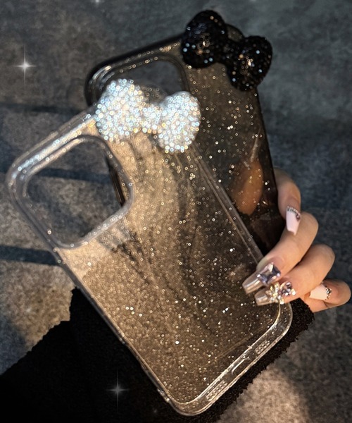 Vini(ヴィニ)の「キラキラ リボン ラメ入り クリア iPhone ケース 13.13Pro.14.15.15Pro.16.16Pro.17(スマホケース/カバー・レディース・シルバー/ブラック・iPhone 13/iPhone 13 Pro/iPhone 14/iPhone 15/iPhone 15 Pro/iPhone 16/iPhone 16 Pro)」の1枚目の写真