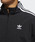 adidas�i�A�f�B�_�X�j�́u�g���b�N�W���P�b�g [LOCK UP TRACK TOP] �A�f�B�_�X�I���W�i���X�i�i�C�����W���P�b�g�j�v�b�ڍ׉摜