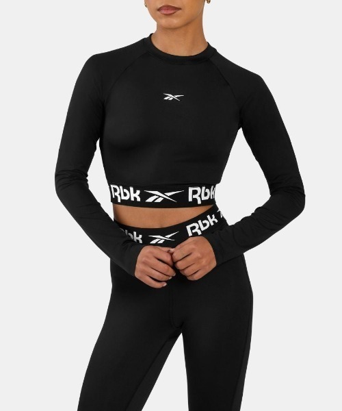 Reebok(リーボック)の「トレイン カットアウト ロングスリーブ / ID TRAIN CUTOUT LONG SLEEVE(その他トップス・レディース・ピンク/ブラック・SMALL/MEDIUM/LARGE/X-SMALL)」の1枚目の写真