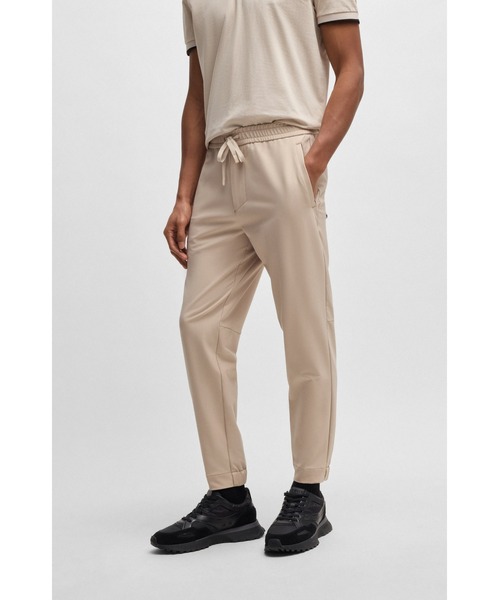 BOSS(ボス)の「テーパードフィットパンツ はっ水ストレッチファブリック(スウェットパンツ・メンズ・ダークブルー/ベージュ/ブラック・52/48/46/50/44/56/54)」の1枚目の写真