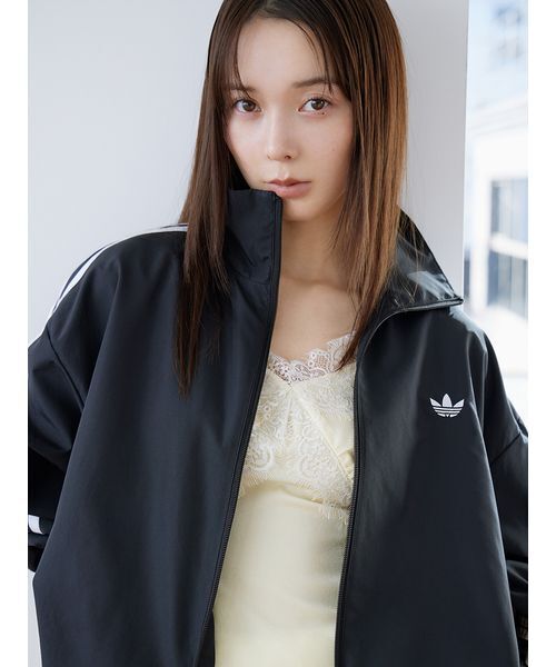 adidas(アディダス)の「【adidas Originals】FIRE BIRD ADILENIUM TT/ファイヤーバードアディレニウムトラックジャケット(ブルゾン・レディース・ブラック・XS)」の1枚目の写真