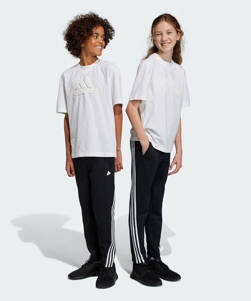 adidas（アディダス）の「フューチャーアイコン スリーストライプス アンクルパンツ / アディダス adidas（その他パンツ・キッズ・パープル/ブラック・150/160/130/140）」の2枚目の写真