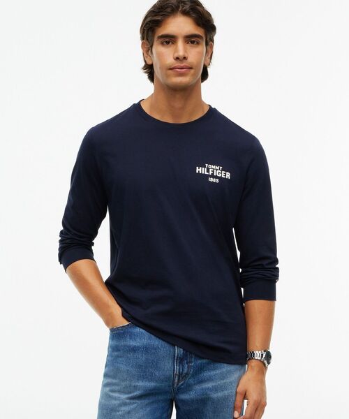 TOMMY HILFIGER(トミーヒルフィガー)の「1985グラフィックロングスリーブTシャツ(Tシャツ/カットソー・メンズ・ホワイト/ネイビー/グリーン・MEDIUM/SMALL/LARGE/X-LARGE)」の1枚目の写真