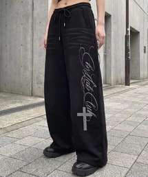 ARULE（アルール）の「A'GEM/9 × .kom 『ARULE/アルール』 クロスレタリングワイドスウェットパンツ（スウェットパンツ）」