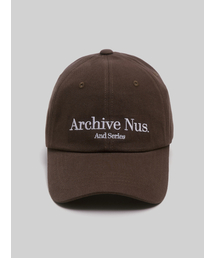 HUKE（ヒューク）の「Nus. arch ball cap (Brown)（キャップ）」