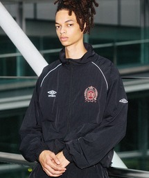 UMBRO（アンブロ）の「UMBRO別注 スタンドネックパイピングドローコードナイロントラックジャケット（ナイロンジャケット）」
