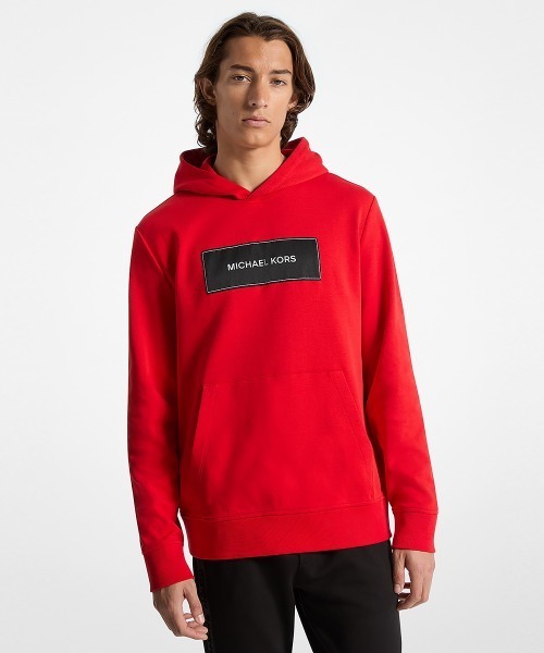 【新品】MICHAEL KORS ロゴテープ フリルジップフーディー　L MICHAEL KORS（マイケルコース）の「ロゴテープ ジップ
