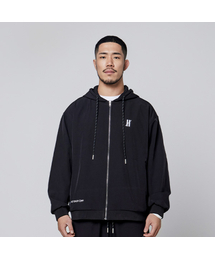 OVERTIA（オーバーシャ）の「Functional fleece warm-up oversized hooded zip-up in black（ジャージ）」