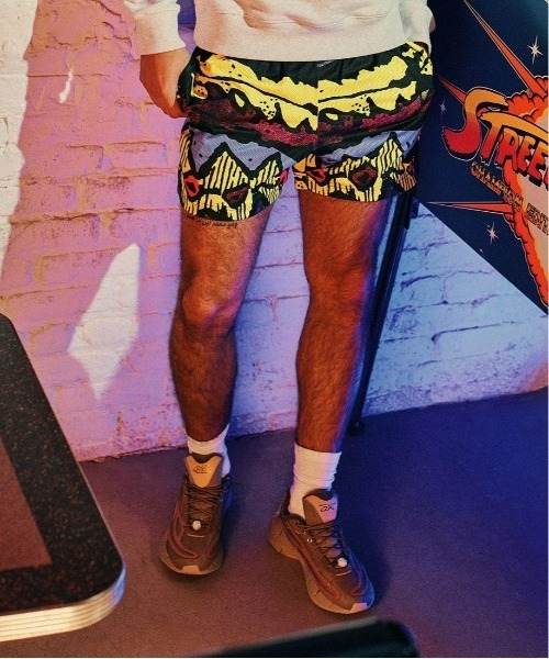 Reebok(リーボック)の「ストリート ファイター オールオーバー プリント ショーツ / Street Fighter Allover Print Shorts(その他パンツ・メンズ・ブラック・MEDIUM/SMALL/XX-LARGE/X-LARGE/LARGE/XXX-LARGE/X-SMALL)」の1枚目の写真