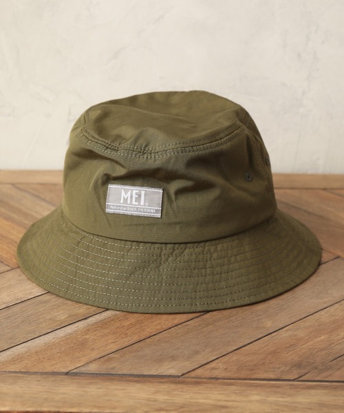 MEI(メイ)の「【MEI/メイ】ワンポイントロゴ バケットハット(ハット・メンズ・ホワイト/ブラック/ダークグリーン/ベージュ/ネイビー/オレンジ/ブルー/ライトグリーン/マスタード・FREE)」の1枚目の写真
