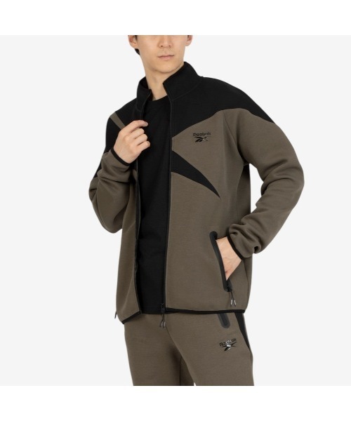 Reebok(リーボック)の「ビッグベクター ジャケット / CONTRAST PANEL FUNNELNECK JACKET(ジャージ・メンズ・アーミー/チャコールグレー×ブラック/グレー・X-LARGE/SMALL/MEDIUM/LARGE)」の1枚目の写真