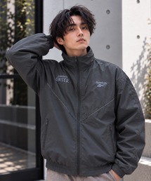 Reebok（リーボック）の「REEBOK パイピング ポケットジップ付き ナイロンジャケット（ナイロンジャケット）」