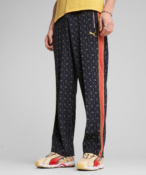 PUMA(プーマ)の「PUMA プーマ メンズ ロード トゥ ユニティ AOP リラックス ストレート トラック パンツ(その他パンツ・メンズ・レッド系その他/ネイビー・SMALL/X-LARGE/LARGE/MEDIUM/X-SMALL/XX-LARGE)」の1枚目の写真