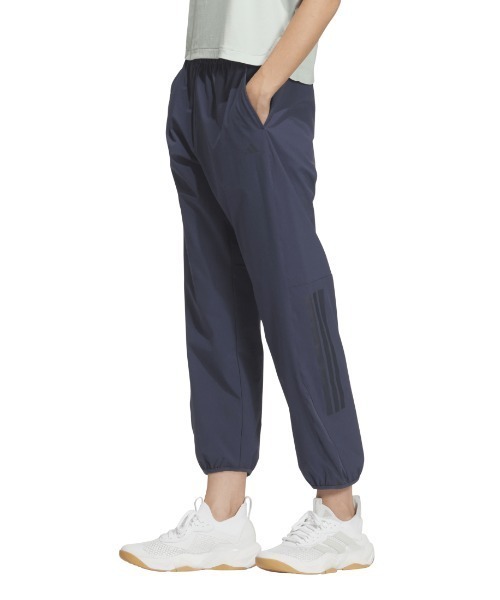 adidas(アディダス)の「アディダス adidas エッセンシャルズ プラス ルーズフィット ストレッチ ウーブン 9/10 テーパード パンツ(その他パンツ・レディース・ブラック/ネイビー・S/M/L)」の1枚目の写真